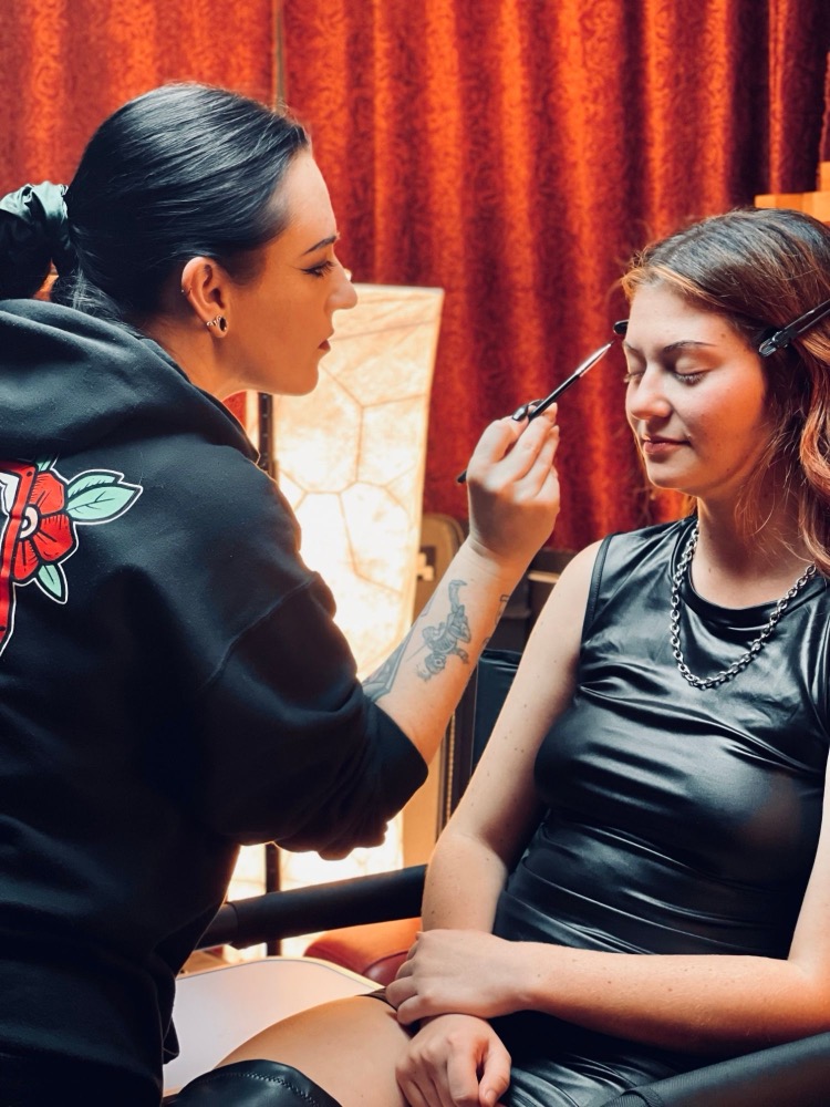 Rebecca applying the singer's eye makeup before the shoot